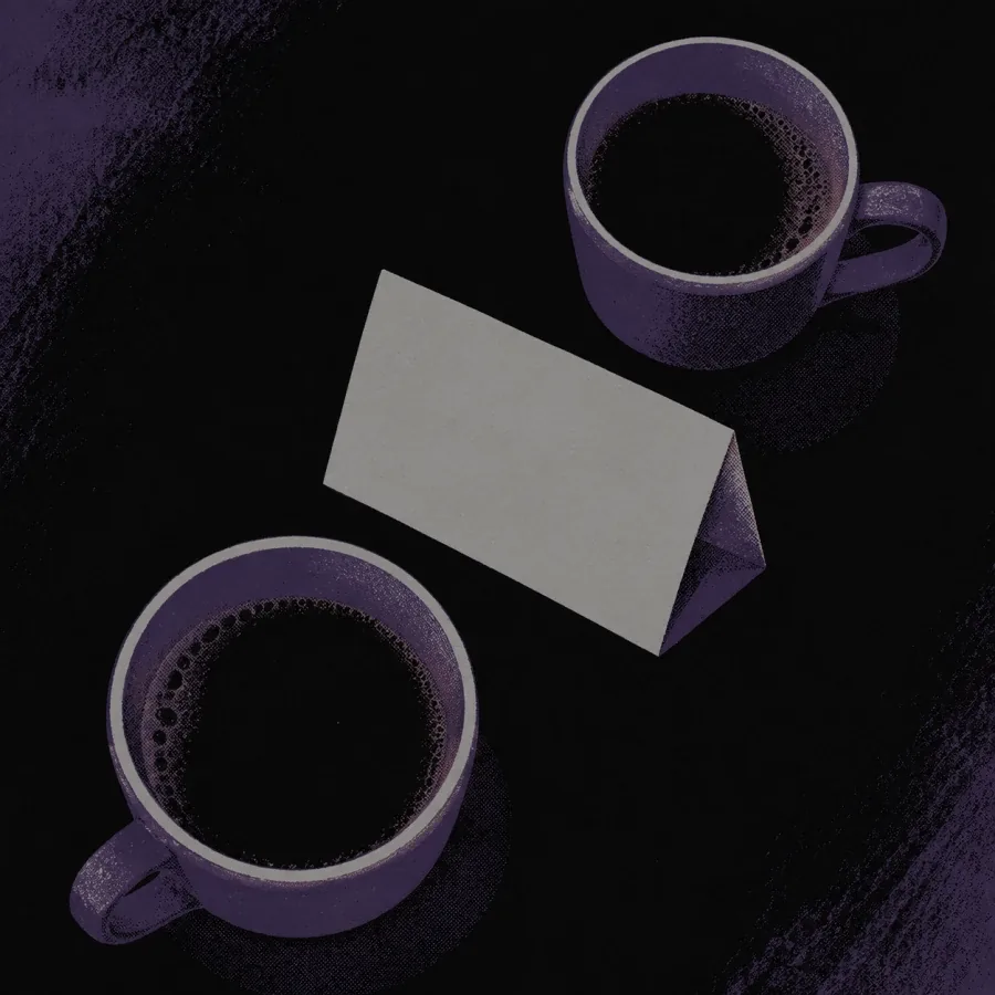 Two cups on a small table with an empty chair pulled up
